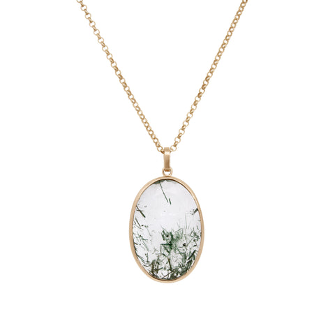 Gold necklace with an oval pendant featuring a green and white pattern on a white background