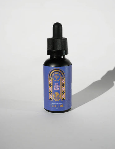 Bottle of 'Yes to the Nails' cuticle oil with a decorative label on a white background