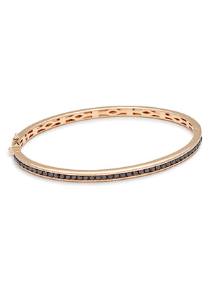 A bracelet with a line of black diamonds set around the band set in yellow gold.