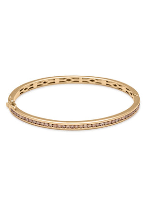 A bracelet with a line of champagne diamonds set around the band set in yellow gold.