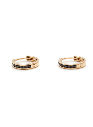 A pair of hoops with a line of black diamonds set in yellow gold both on their side.