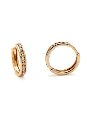 A pair of hoops with a line of champagne diamonds set in yellow gold one earring angled.