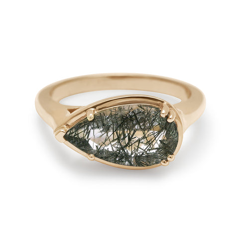 A solitaire ring pear shaped black rutilated quartz set in yellow gold.