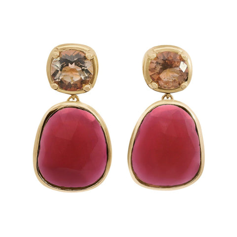 A pair of drop earrings featuring a cushion cut sunstone and a pink tourmaline slice set in yellow gold on a white background