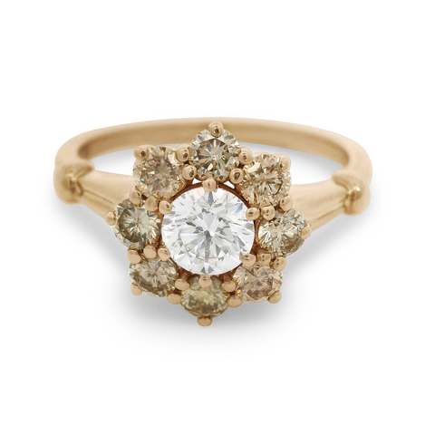 A cluster engagement ring with a white diamond center stone and champagne diamond side stones surrounding it set in 14k yellow gold., Yellow Gold
