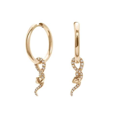 A pair of hoop earrings with a serpent charm at the bottom with white diamond pave set in yellow gold one earring angled.