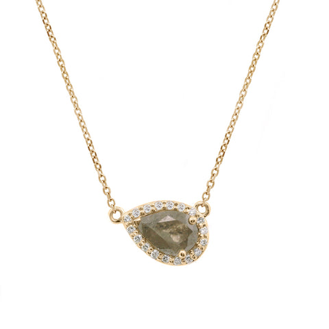 Zoomed in view of a pear necklace with a grey diamond center with white diamond halo in yellow gold with a yellow gold chain.