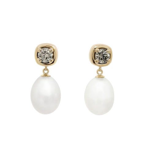 A drop earring with a .36ct round champagne diamond and fresh water pearl. Set in 14k yellow gold.