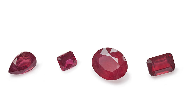 4 ruby stones in a variety of shapes and cuts.