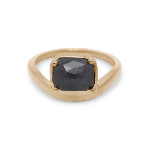 Gold ring with a black gemstone on a white background