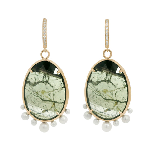 Pair of earrings with green gemstones and pearl-like beads on a white background