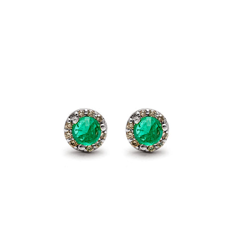 A pair of tiny emerald center stone earrings with a halo of champagne diamond set in sterling silver.