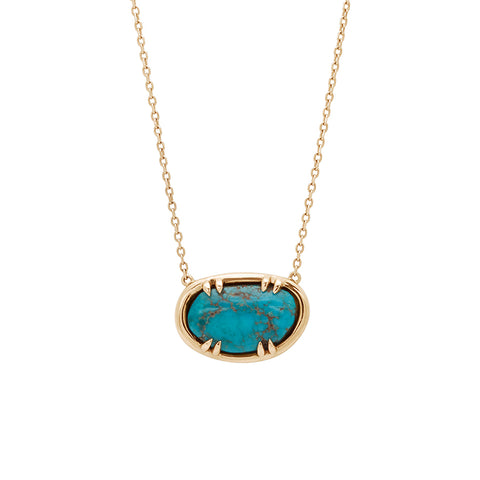 Zoomed in view of an oval necklace with a turquoise stone set in bezel with claw prongs in yellow gold with a yellow gold chain.