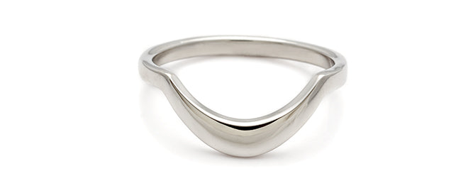 a 14k white gold wedding band with a curved shape