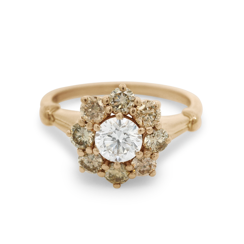 A cluster engagement ring with a white diamond center stone and champagne diamond side stones surrounding it set in 14k yellow gold., Yellow Gold