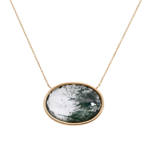 Yellow gold necklace with a clear quartz with greenish black inclusions as a pendant on a white background