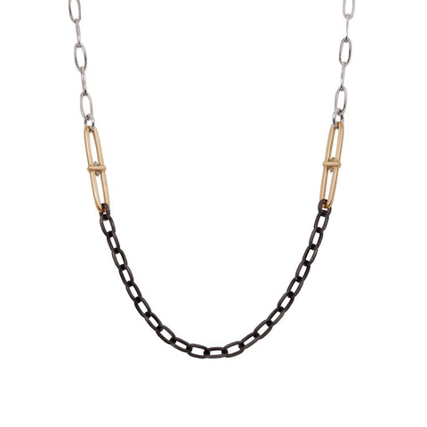 Necklace with black and gold paperclips mottifs with white diamonds on a silver chain on a white background