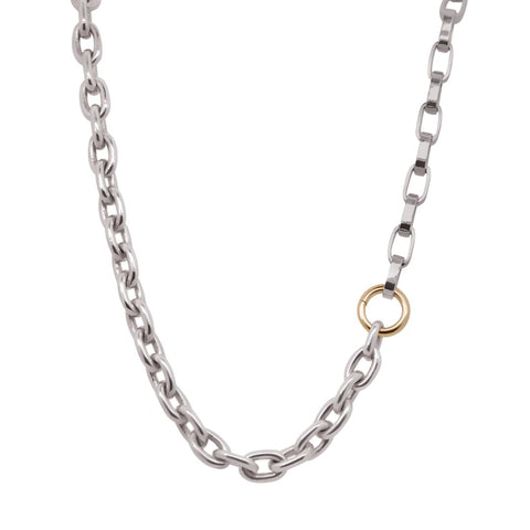 Silver chain necklace with a gold ring pendant on a white background