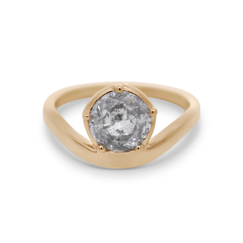 A yellow gold ring featuring a round grey diamond on a white background