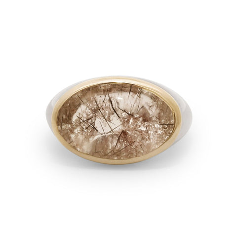 A terra firma cabochon quartz signet ring bezel set in a 14k yellow gold bezel and sterling silver shank. 