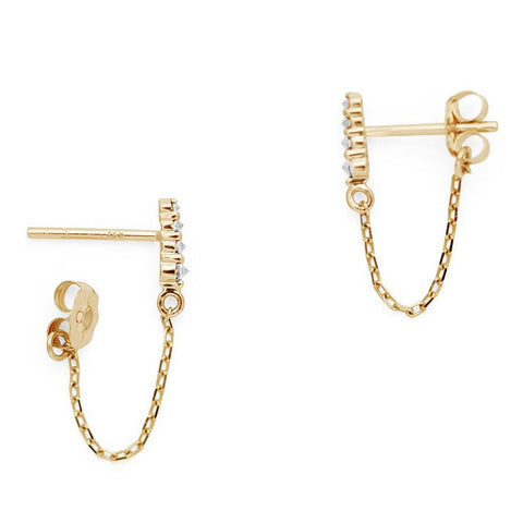 Side view of a pair of earrings with four white diamonds with a chain connecting to the ear back set in yellow gold., Yellow Gold 2