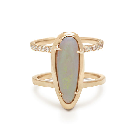 A double banded engagement ring with white diamond pave around one of the bands in the center an oval opal stone set in yellow gold bezel with claw prongs.