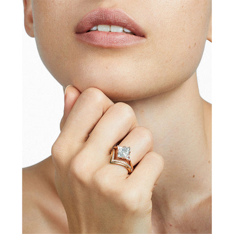 A three stone engagement ring with a marquise shape grey diamond center stone with two white diamond trillion side stones set in rose gold stacked above a diamond dusted chrysalis shaped band on a light-complexion left hand., White Gold, Rose Gold, Yellow Gold 3