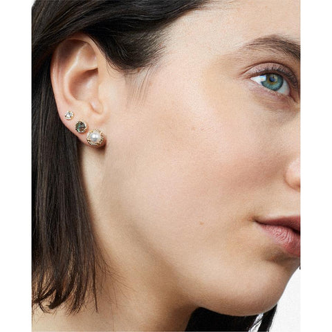 A light-complexion model with three halo studs on her ear, two medium sized and one tiny. 3