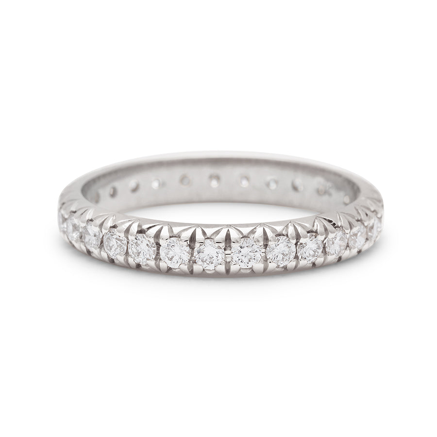 A white gold band with an eternity of round white diamond stones., White Gold