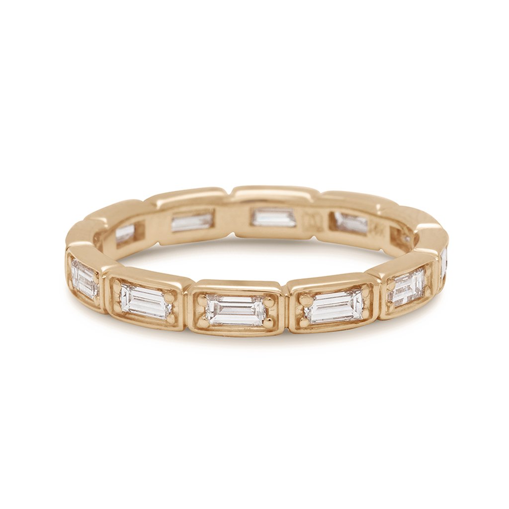 A white diamond baguette band that has diamond goes all around the band set in yellow gold., Yellow Gold