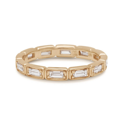 A white diamond baguette band that has diamond goes all around the band set in yellow gold., Yellow Gold
