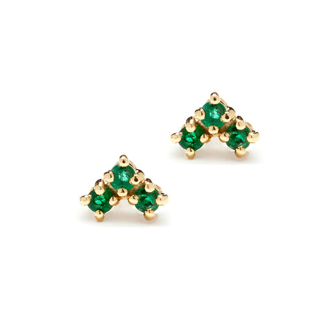 A pair of earrings with three emerald stones set in the shape of an arrow set in yellow gold.