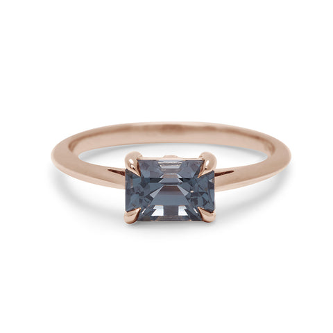 An east/west solitaire ring with an emerald shape grey spinel stone set in rose gold., Rose Gold 3