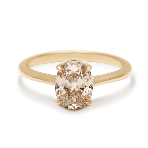 A solitaire oval champagne diamond set in yellow gold., Yellow Gold