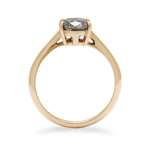 A side view of a solitaire ring oval grey diamond set in yellow gold. 6