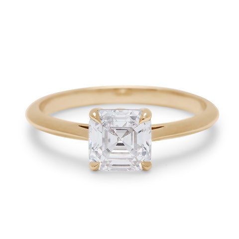 A solitaire ring asscher white diamond set in yellow gold.