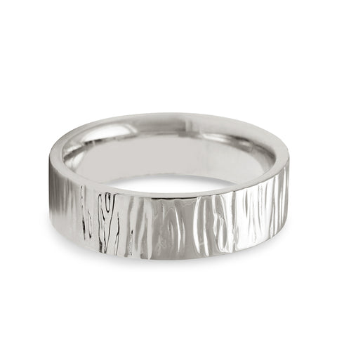 A comfort fit solid gold band with birch engraving on the outside set in white gold., White Gold