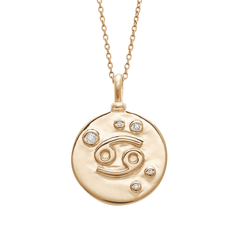 A 18mm charm with the Cancer zodiac sign with white diamond stones set in yellow gold on a yellow gold chain.