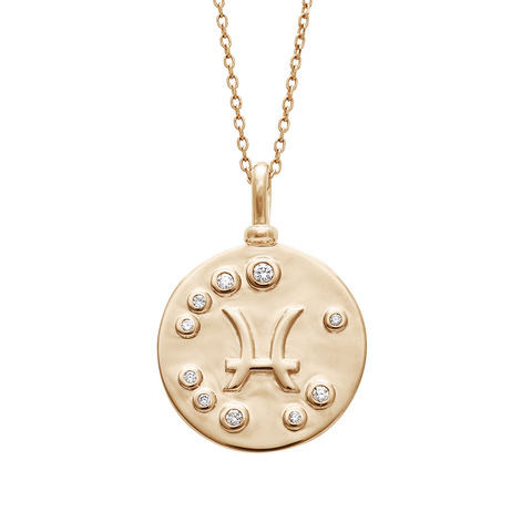 A 18mm charm with the Pisces zodiac sign set in yellow gold with white diamond stones on a yellow gold chain.