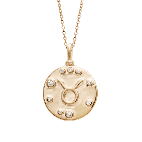 A 18mm charm with the Taurus zodiac sign set in yellow gold with white diamond accent stones on a yellow gold chain.