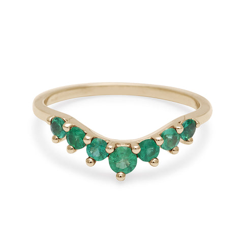 A curved 7 emerald band set in yellow gold., Yellow Gold