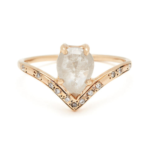 A pear shaped ring with a grey diamond center stone set in yellow gold with white and grey diamonds on the band.