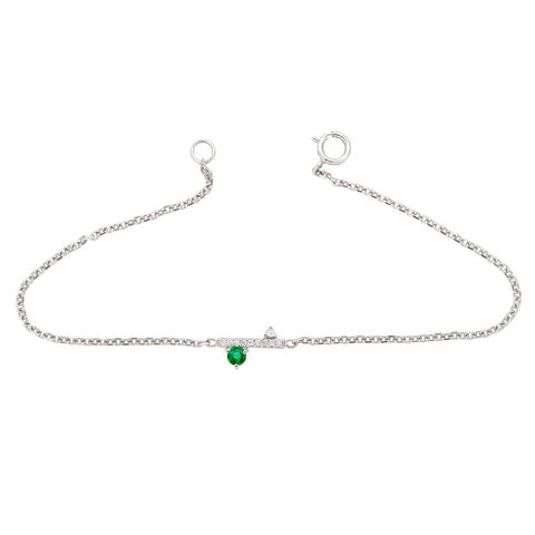 A straight line of white diamond pave with an emerald accent stone on one side set in a white gold chain bracelet., White Gold