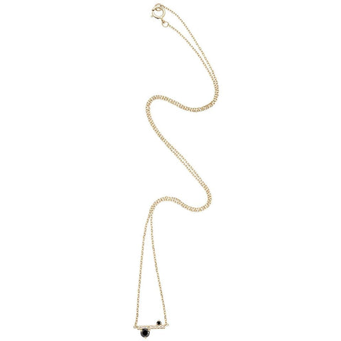 A straight line of white diamond pave with black diamond accent stones on either side set in a yellow gold necklace chain. 2
