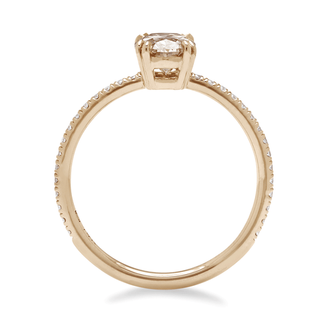 Side view of a solitaire oval champagne diamond ring with double claw prongs with white diamond pave on the band set in yellow gold. 2