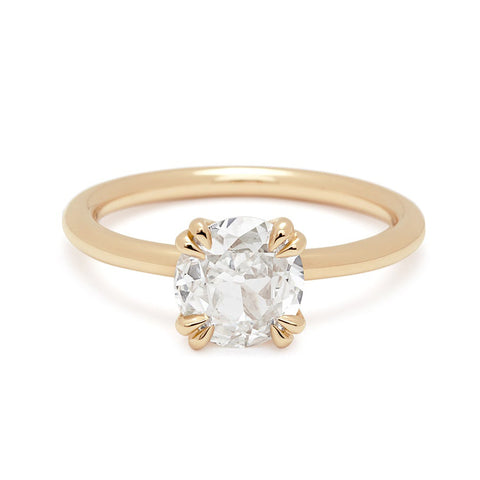 A solitaire round 1.20ct white diamond ring with double claw prongs set in yellow gold.