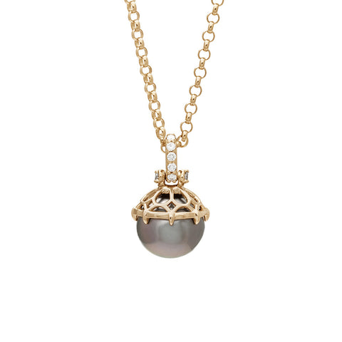 A one of a kind peacock pearl pendant with white diamond pave on the top and grey diamond accent stones on either side on a yellow gold chain.
