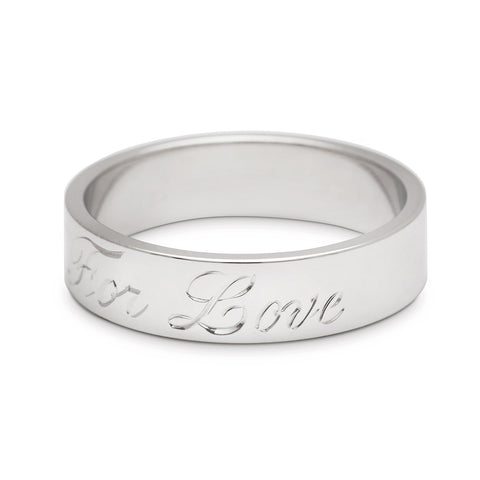 A rotated image of a white gold flat solid gold band with "All For Love" engraved on the outside. 3