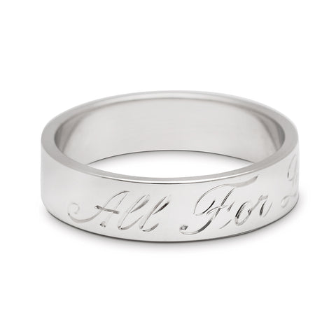 A rotated image of a white gold flat solid gold band with "All For Love" engraved on the outside. 2