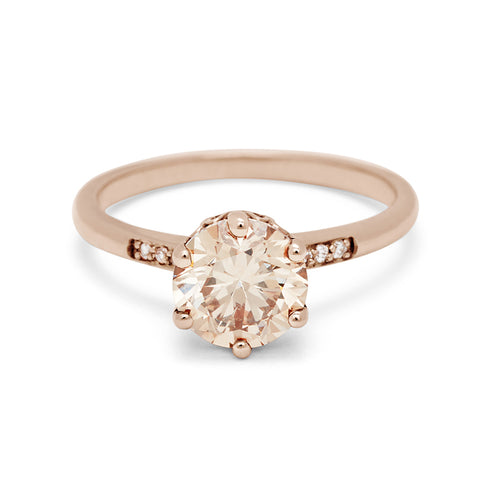 A solitaire ring with a round 1.50ct champagne diamond with white diamond pave on either side set in rose gold., Rose Gold 11